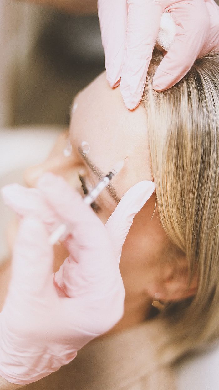Close-up of a cosmetic injection procedure in a modern spa setting, enhancing beauty and wellness.